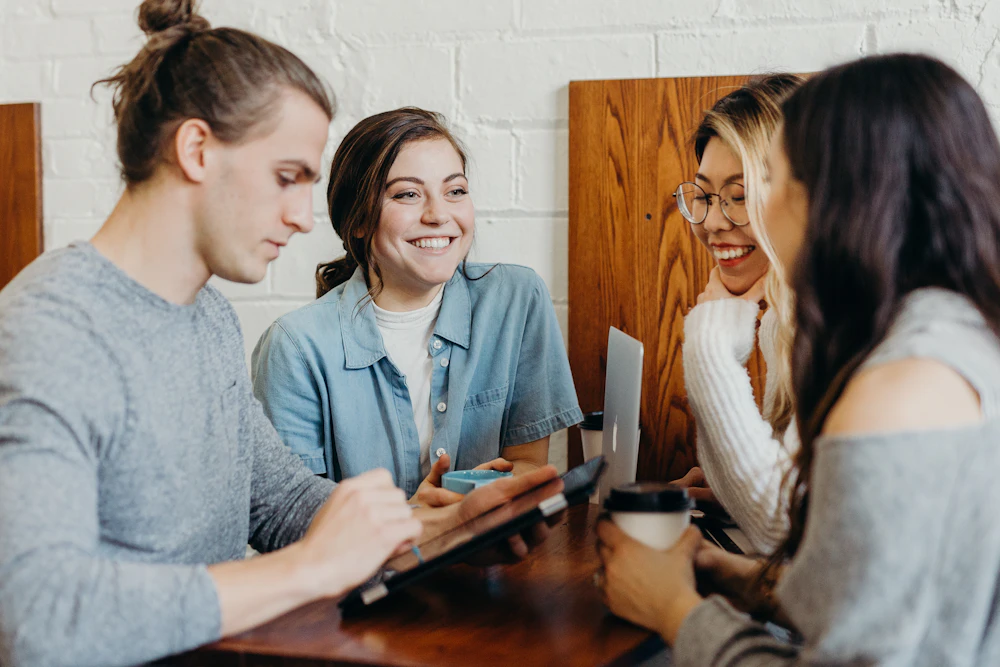 A group of friends gathered around a cafe table
