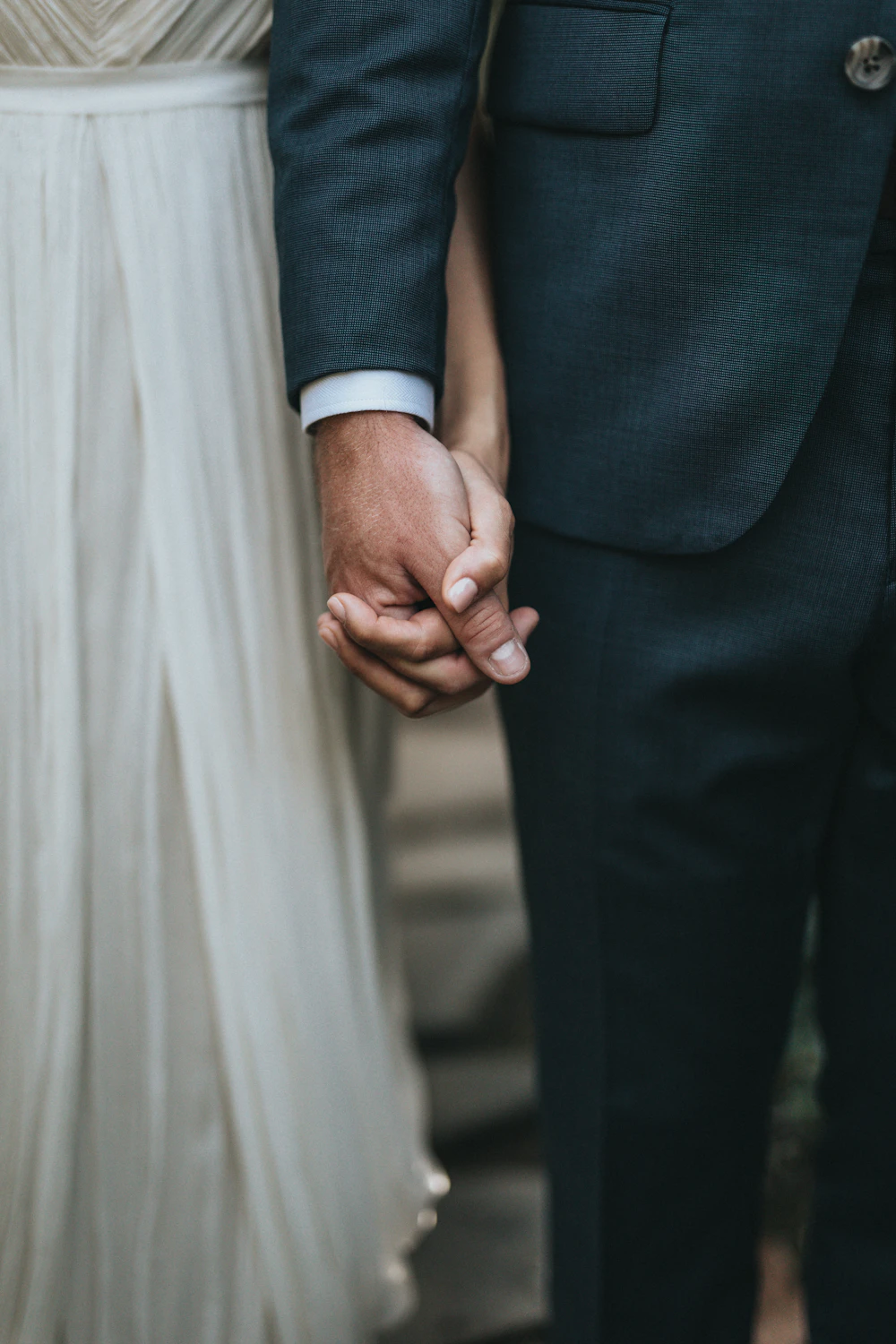 A couple holding hands during a wedding
